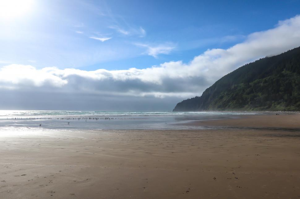 Free Image of Beach on Clear Day with Hill 