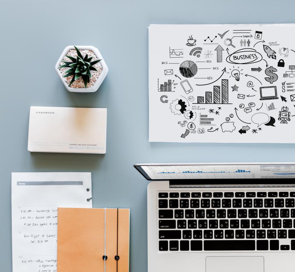 Free Image of Workspace with laptop surrounded with other items on the office table 