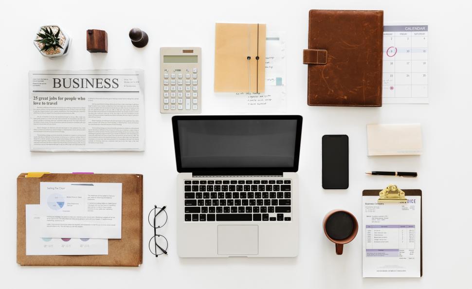 Free Image of Laptop and a coffee mug along with other items in workspace area 