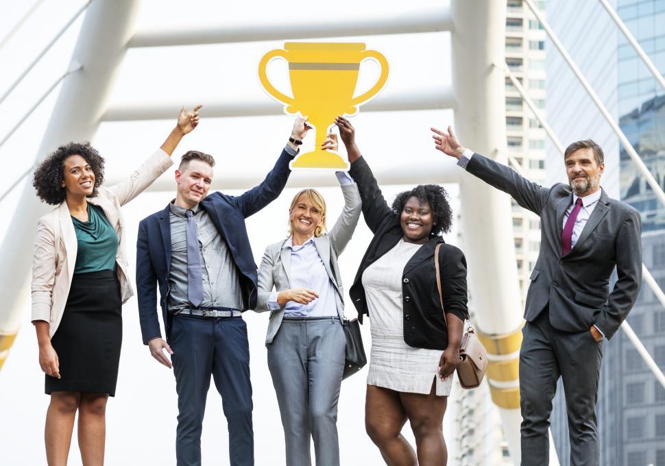 Free Image of Colleagues posing with a trophy cup symbol cardboard cutout 