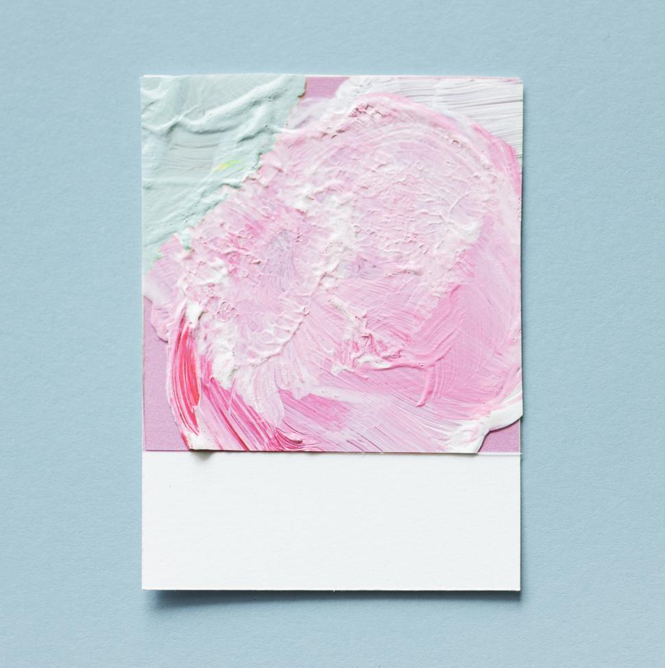 Free Image of Flat lay of green and white brush strokes on spaced cardboard frame 