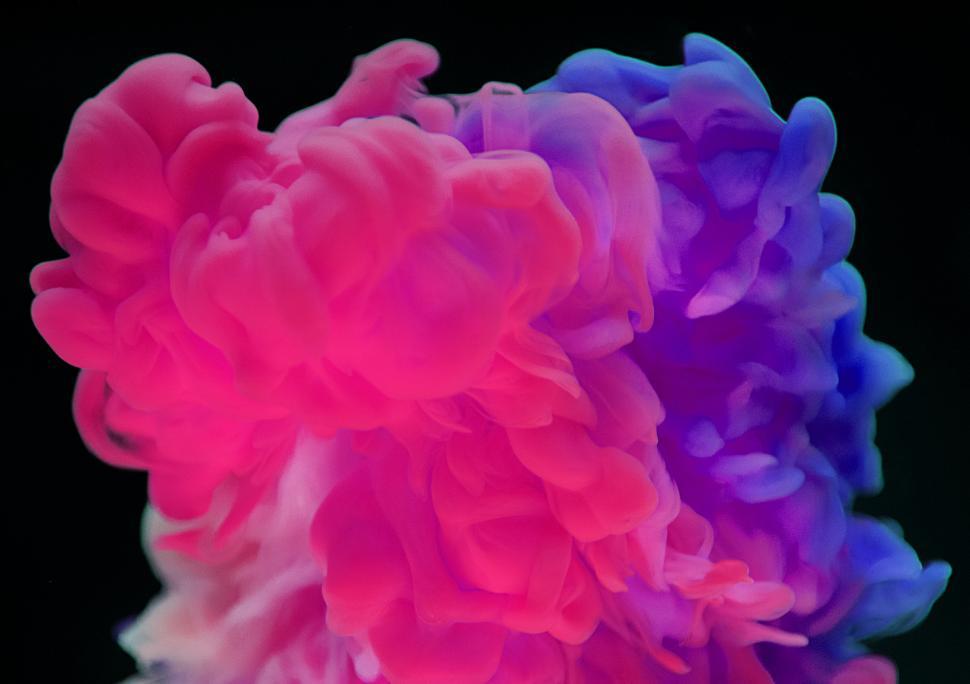 Free Image of An swirling abstract pattern of red and blue ink in water 