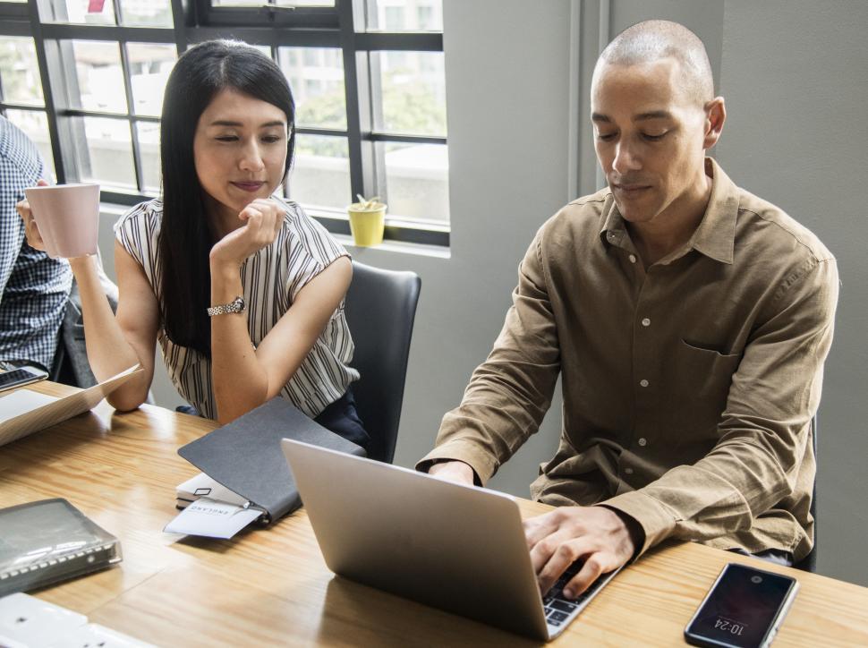 Free Image of People working at a laptop in a meeting 