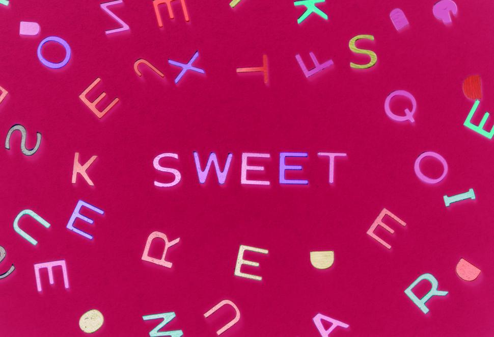 Free Image of Flat lay of the word SWEET written with alphabet blocks 