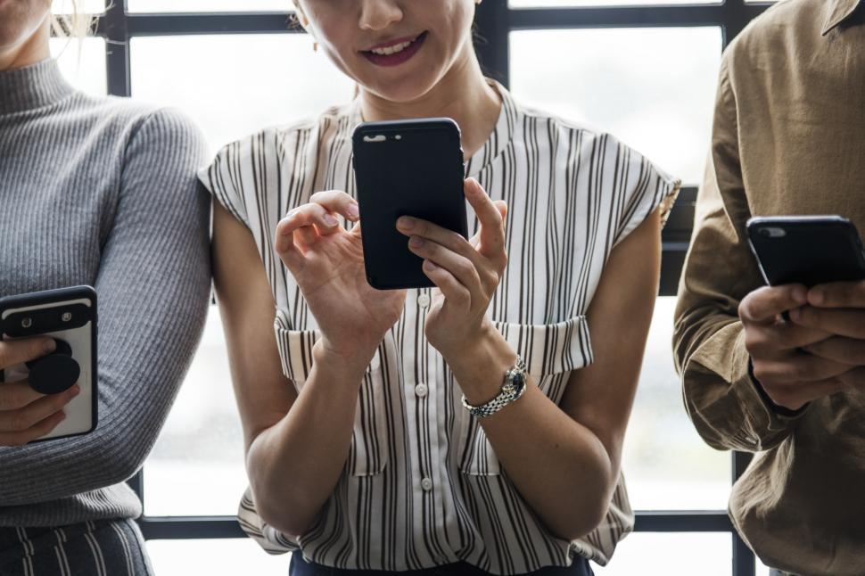 Free Image of Group of woment looking at their mobile phones 