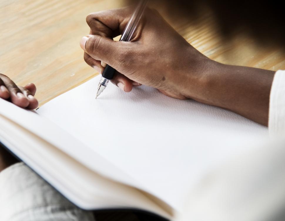 Free Image of Close up of hand writing on a notebook 