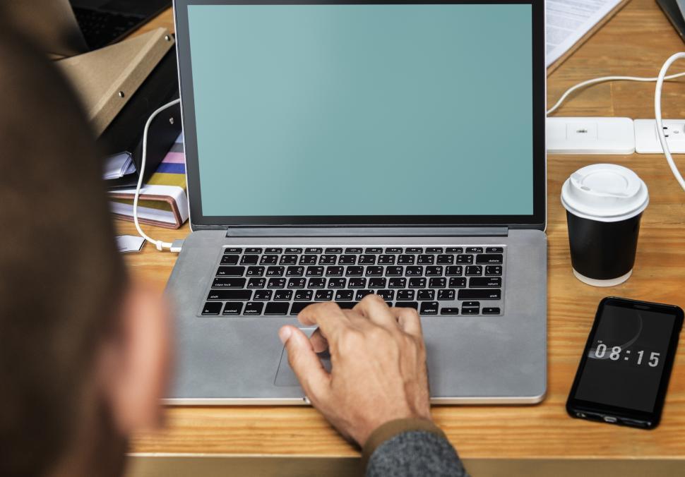 Free Image of Close up of a person s hands typing on blank laptop 
