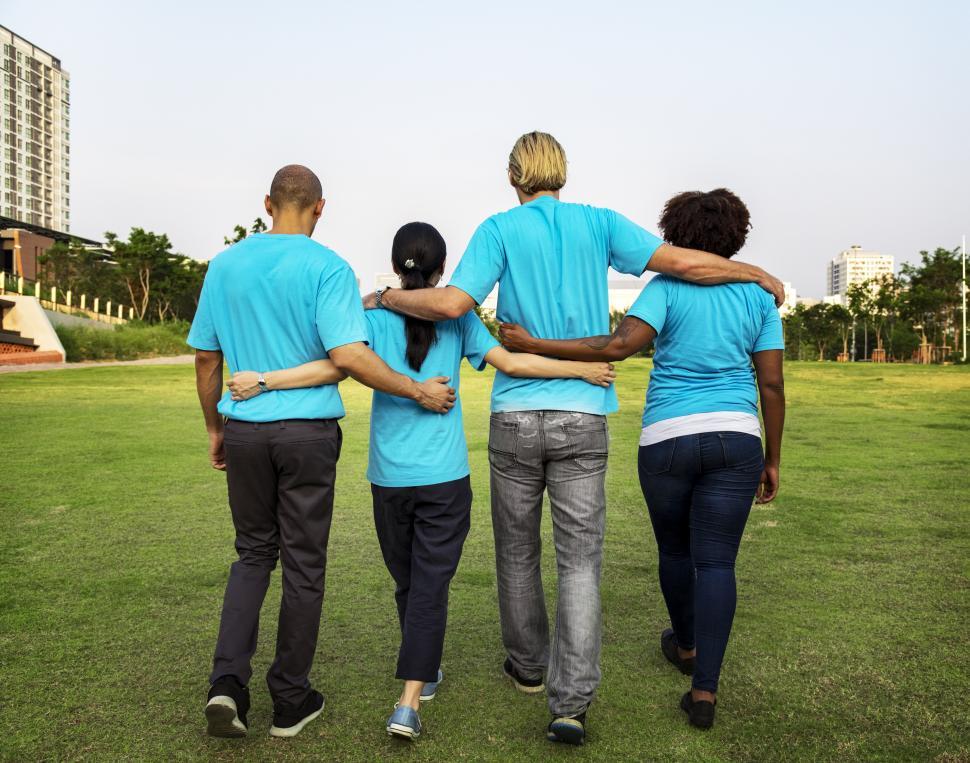 Free Image of A group of volunteers walking together on the grass 