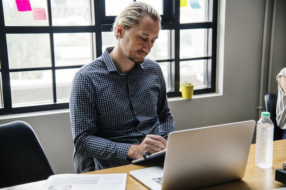 Free Image of A bearded man working with technology 