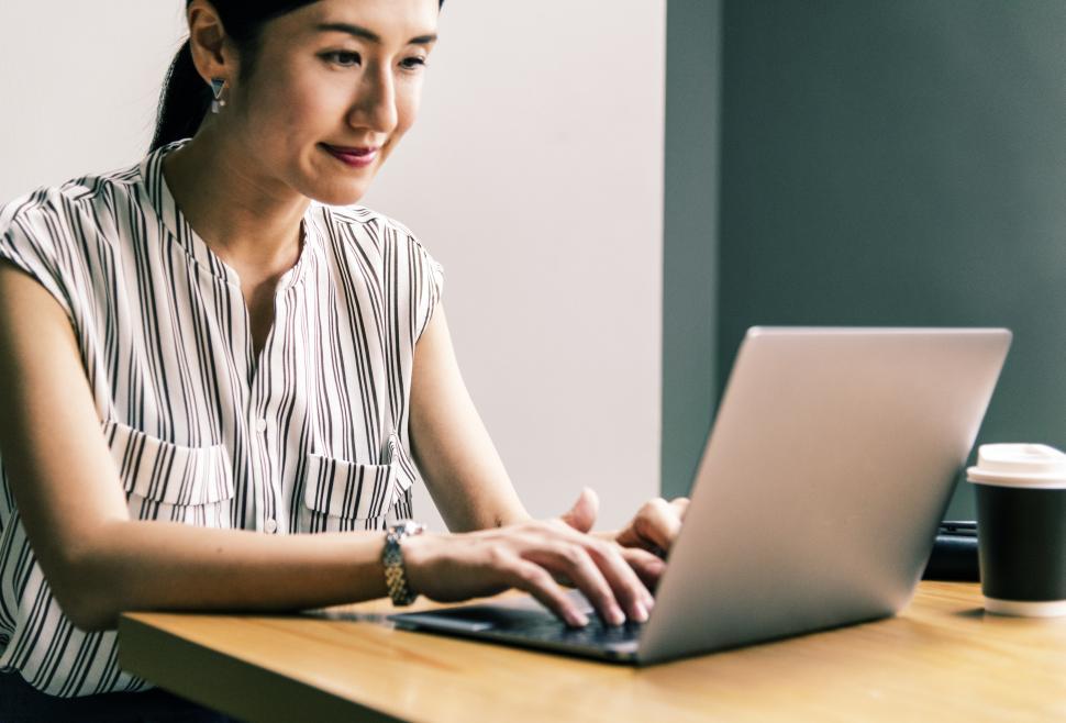 Free Image of A young Asian woman in the office, working 