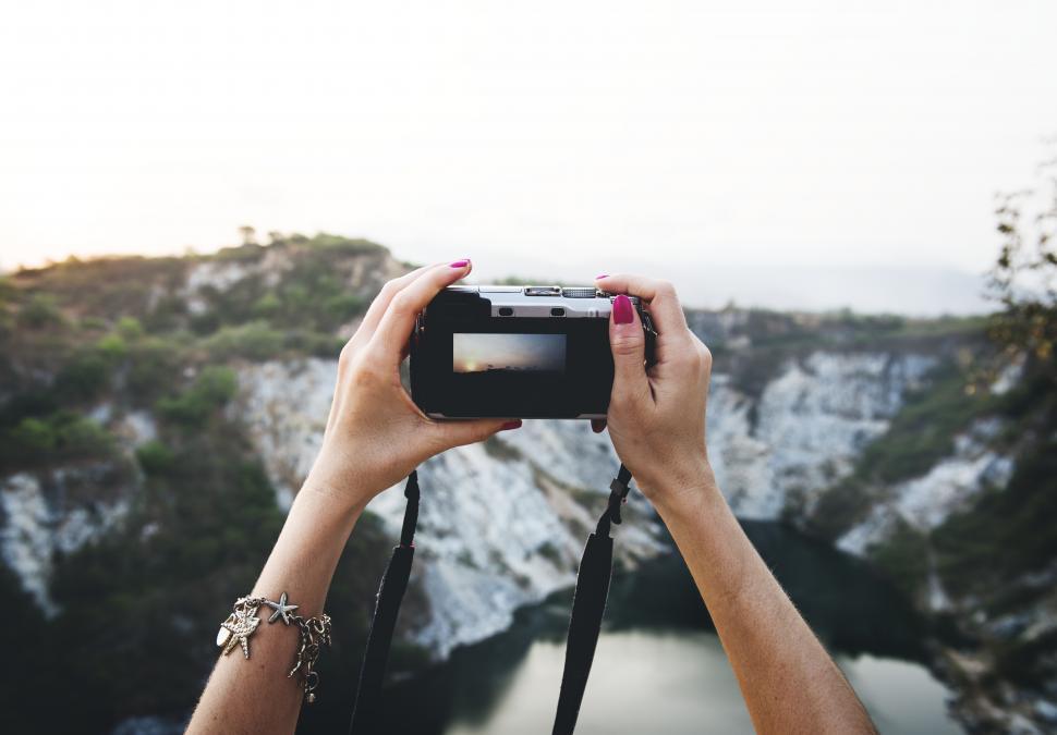 Free Image of Close up a hands holding a camera to take photo 