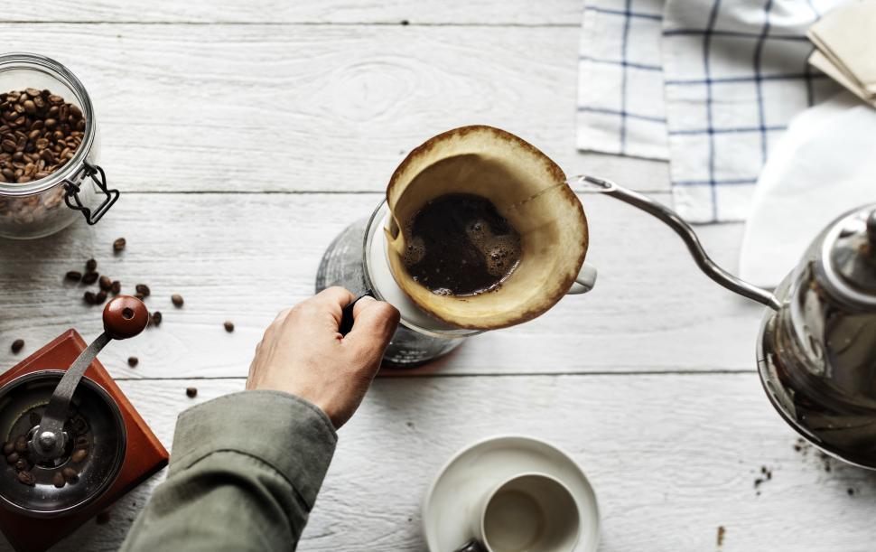 Free Image of Close up of hot water being poured over coffee filter cone 