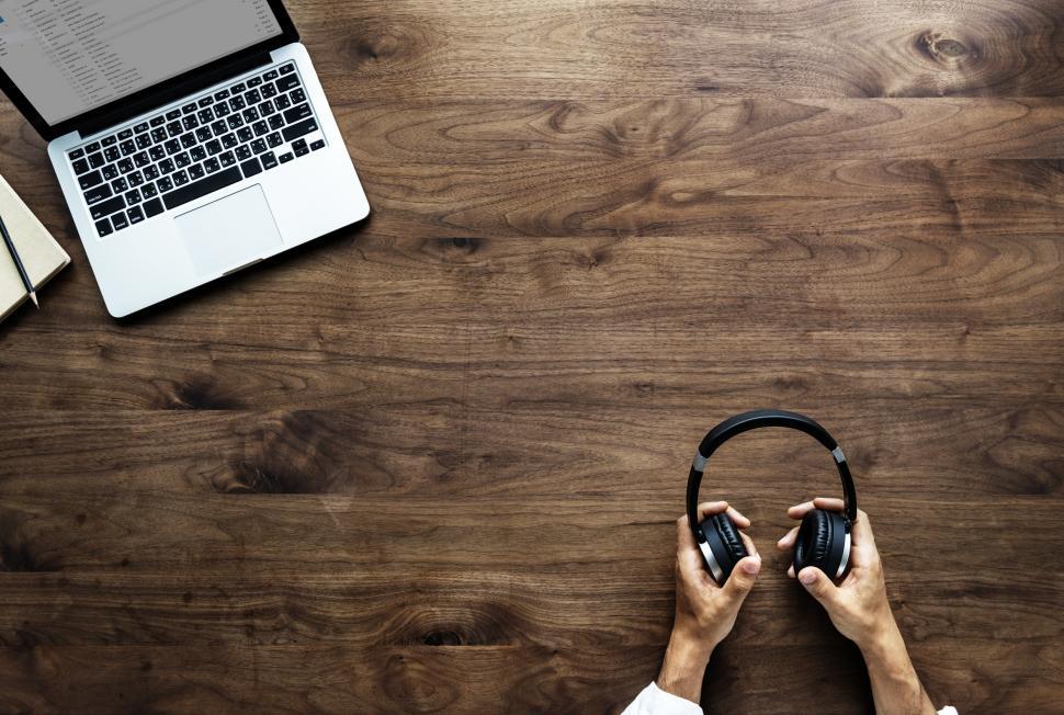 Free Image of Overhead view of hands holding audio headset 