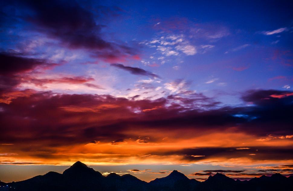 Free Image of Colorful Sunset Sky Over Mountains 