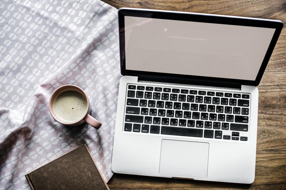 Free Image of Overhead view of a laptop, blank screen, and beverage 