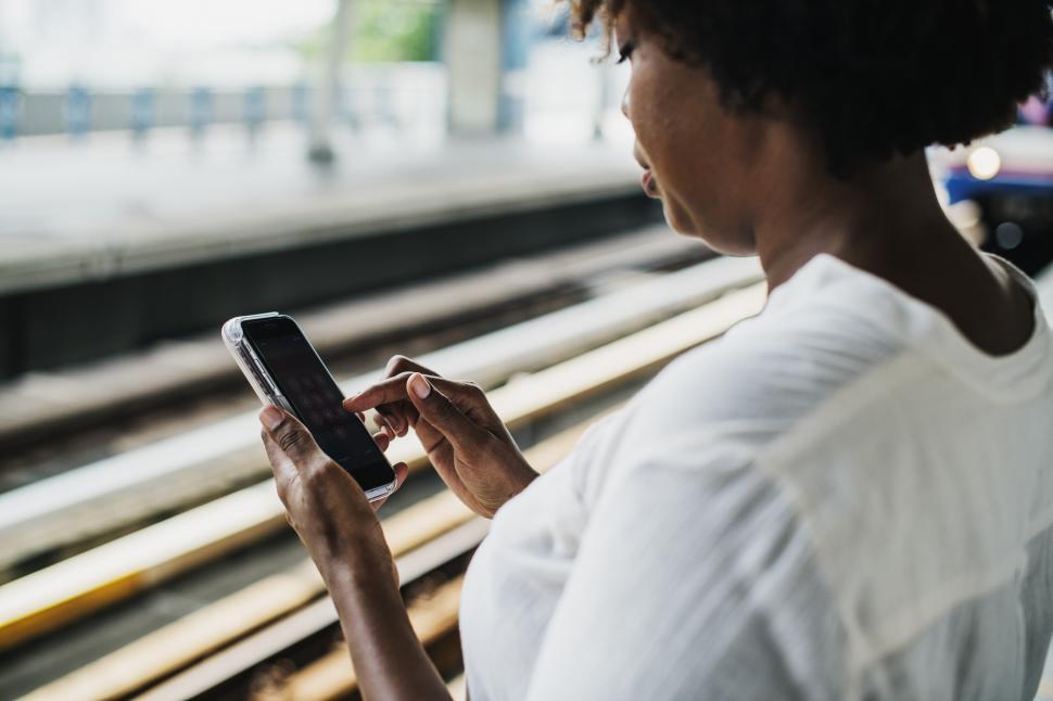 Free Image of A woman dialing her mobile phone 