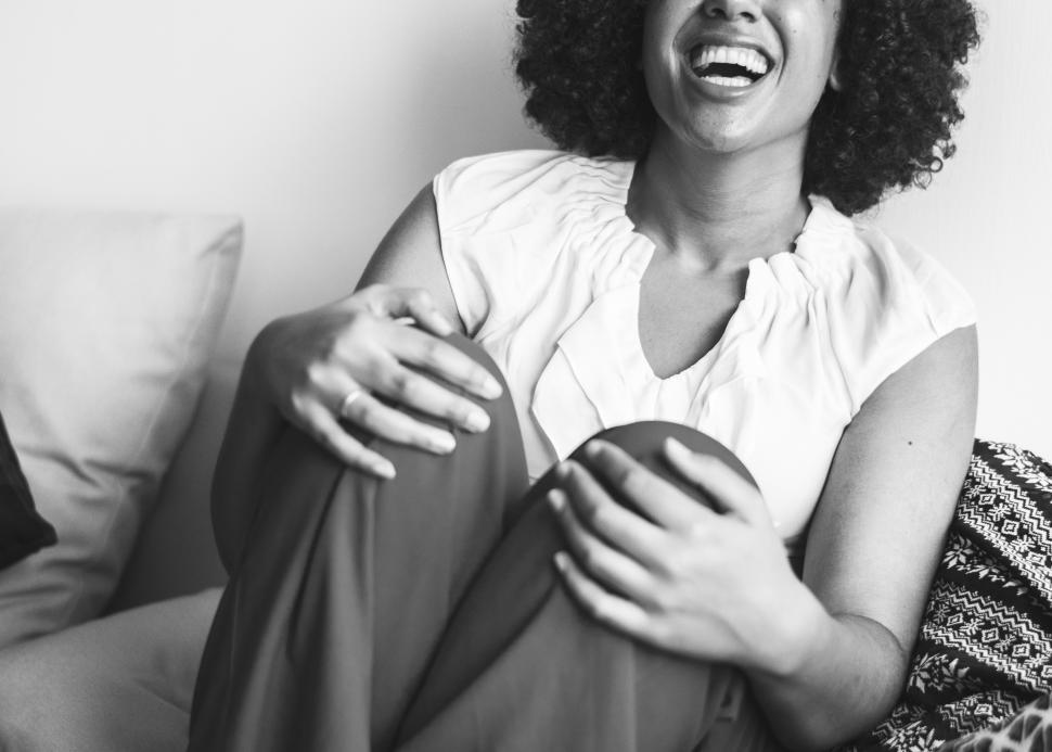 Free Image of A young woman with curly hair laughing - black and white 