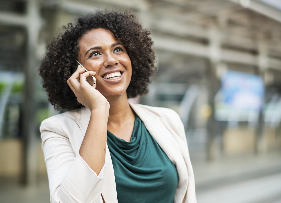 Free Image of A young woman speaking on the mobile phone in the street 