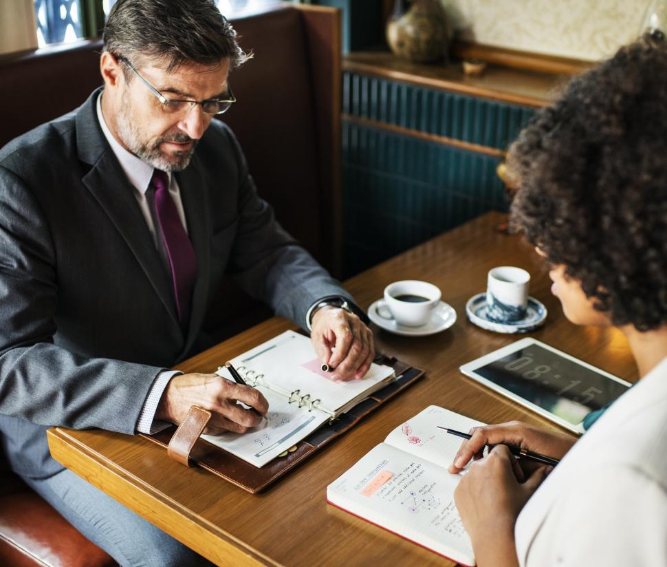 Free Image of A senior Caucasian man and an African ethnicity woman at a cafe 