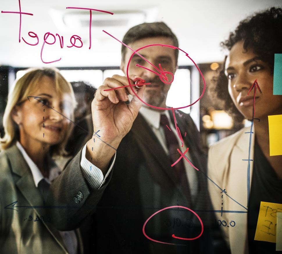 Free Image of  Businessman drawing a graph on a glass panel 