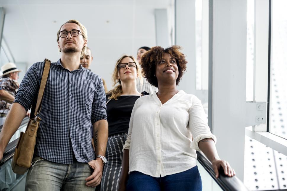 Free Image of A group of commuters on the escalator 