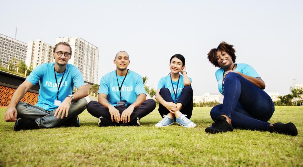 Free Image of A group of multiethnic volunteers sitting on the grass 