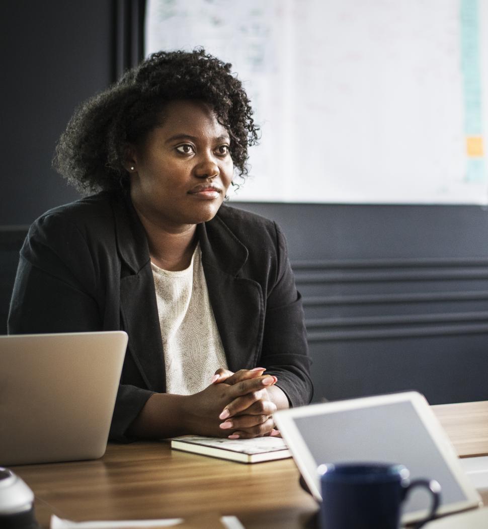 Free Image of A young woman listening in a meeting 