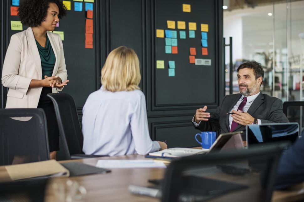 Free Image of A group of colleagues in a meeting with sticky notes 