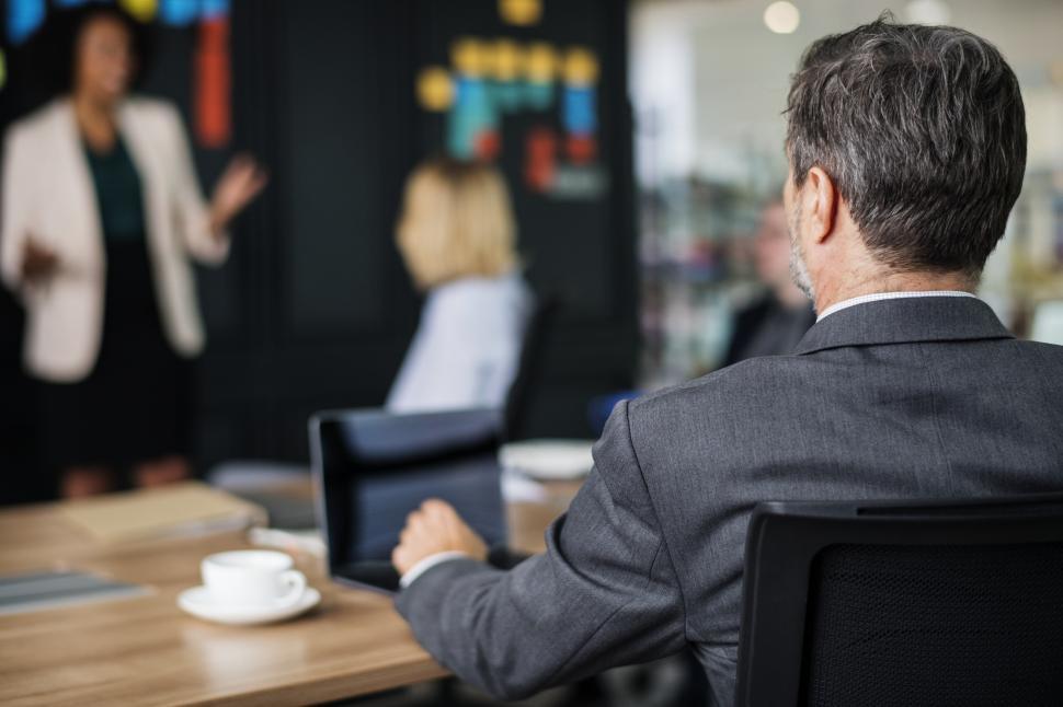 Free Image of Back view of a businessman looking at an office presentation in the office 