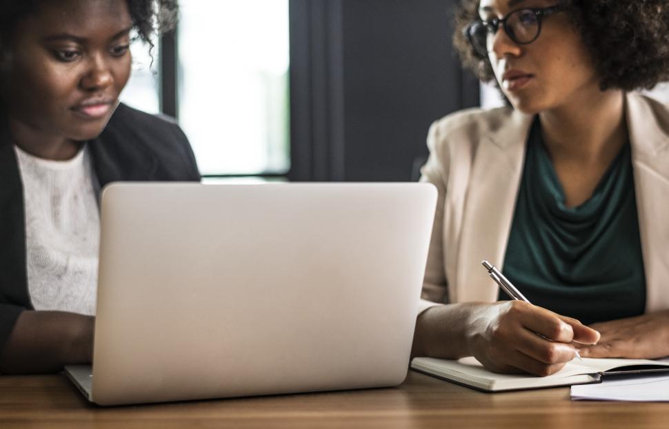 Free Image of Two women in working in the office at a laptop 