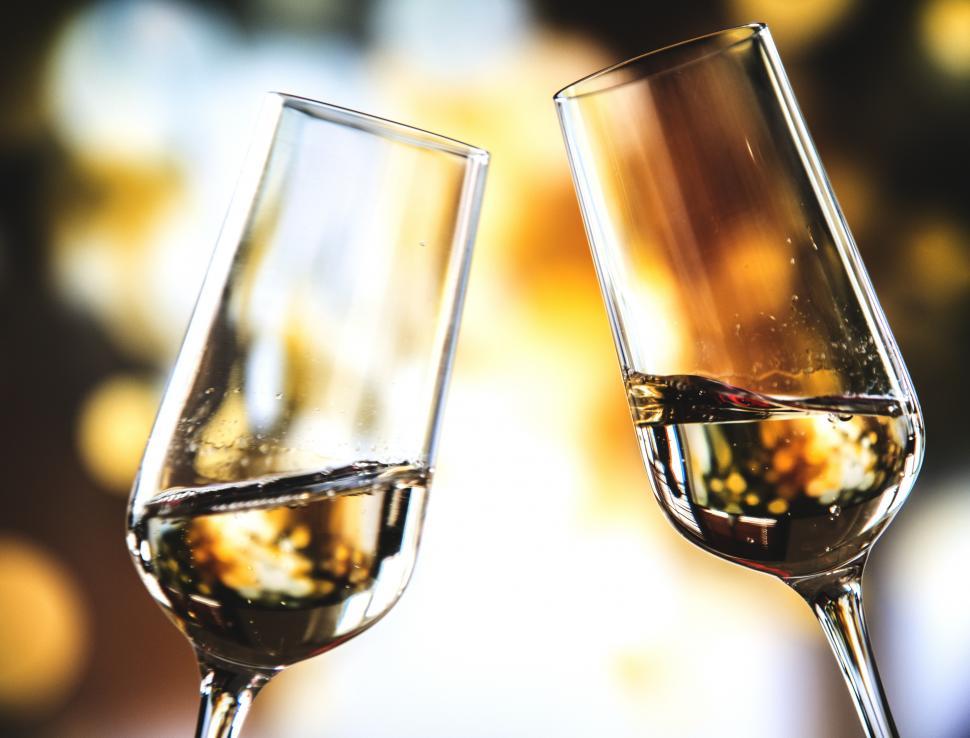 Free Image of Close up of two champagne glasses toasting for celebration 