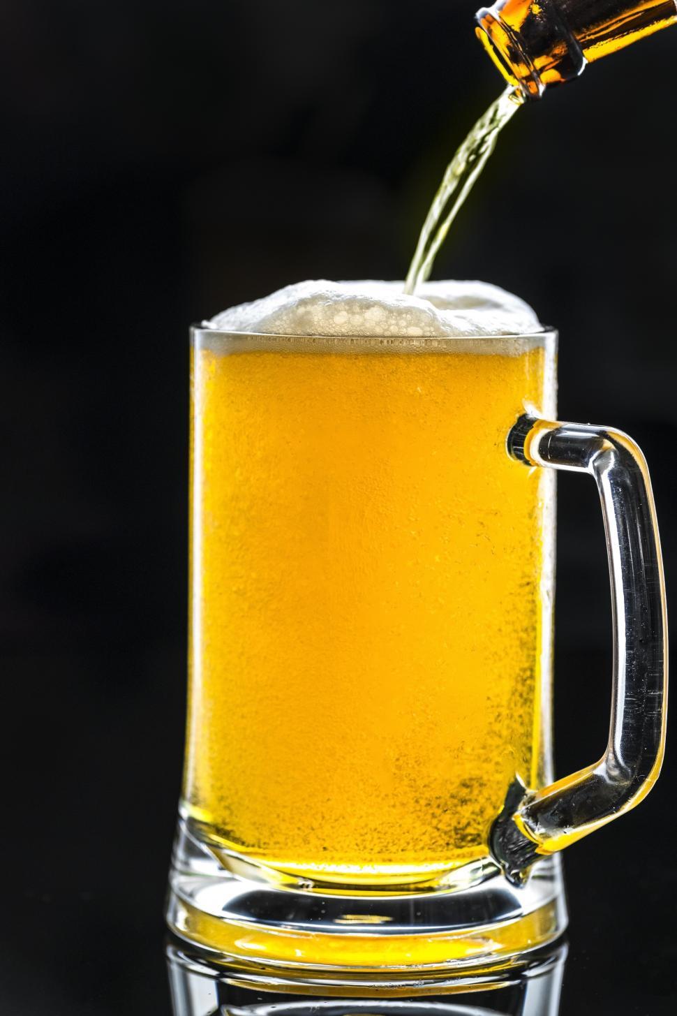 Free Image of Beer being poured into a pint mug 