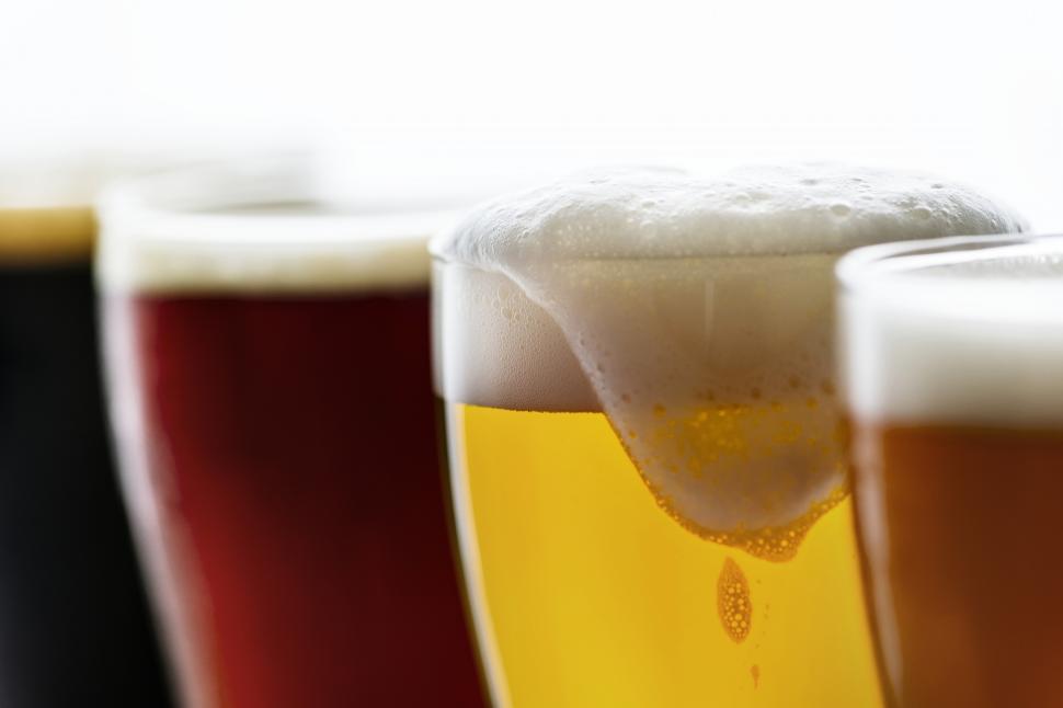 Free Image of Close up of beer foam spilling over lip of glass 