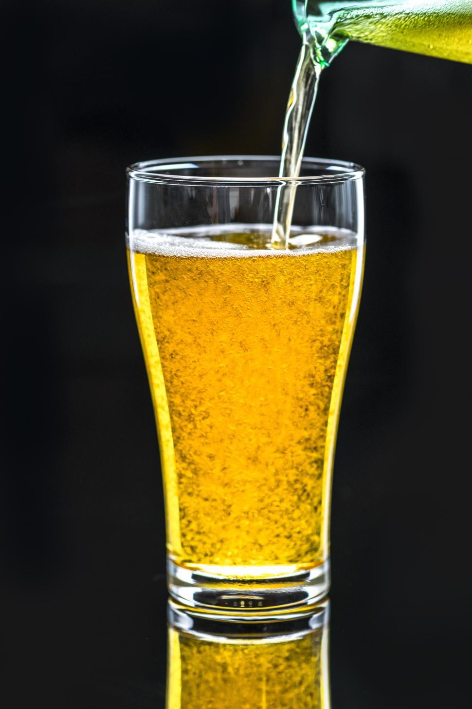 Free Image of Pale beer being poured into a pint glass 