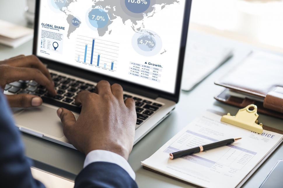 Free Image of Close up of a person typing on the laptop viewing infographics 