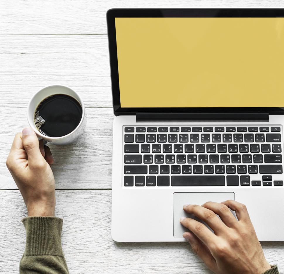 Free Image of Overhead view of a person s hand on laptop - blank screen 