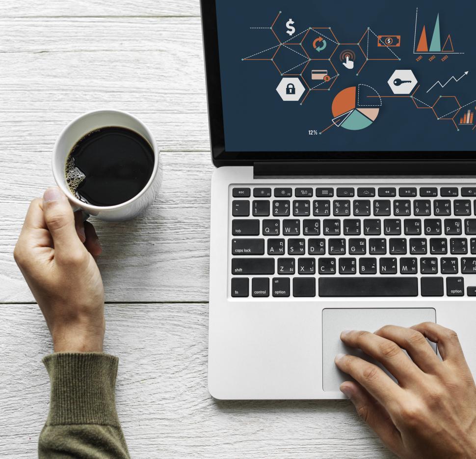 Free Image of Overhead view of a person working with infographics on laptop 