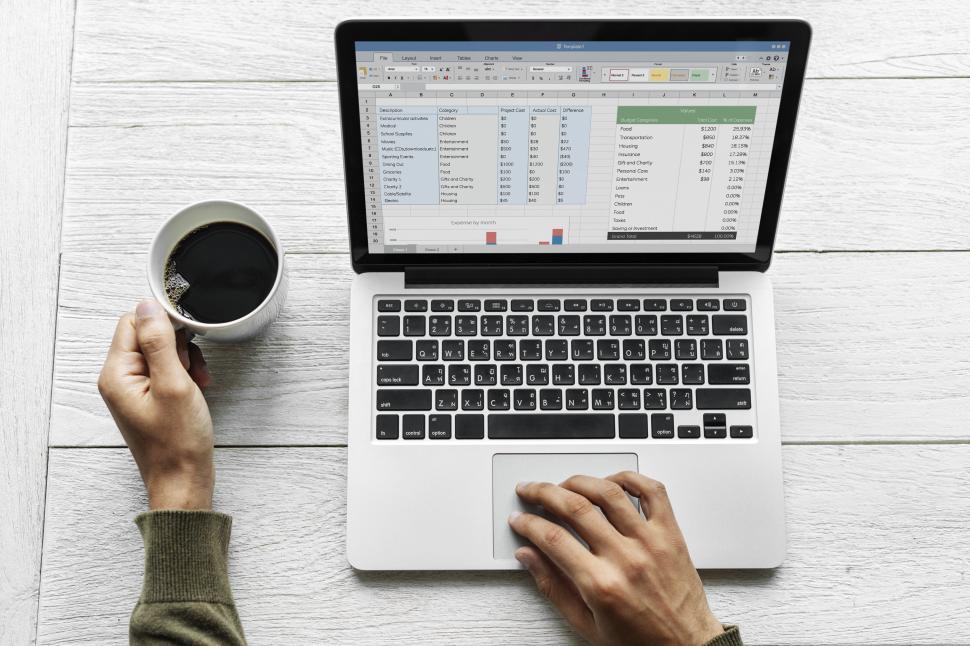 Free Image of Overhead view of laptop with spreadsheet in progress 