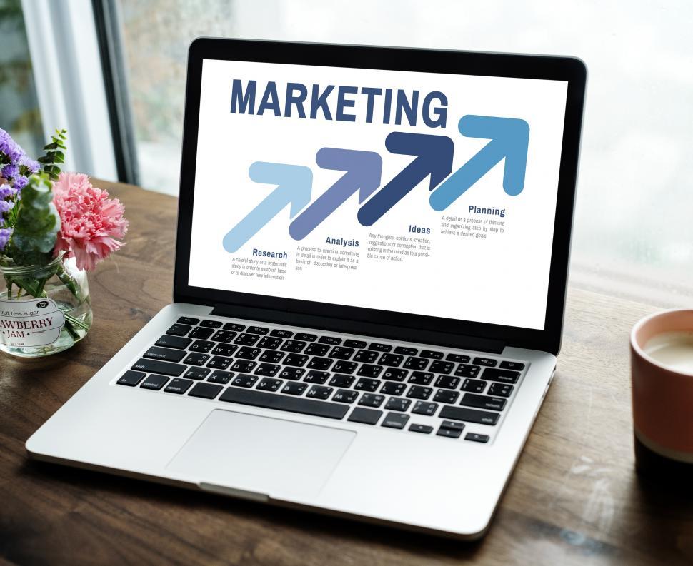 Free Image of Close up of a laptop on the table with marketing graphic 