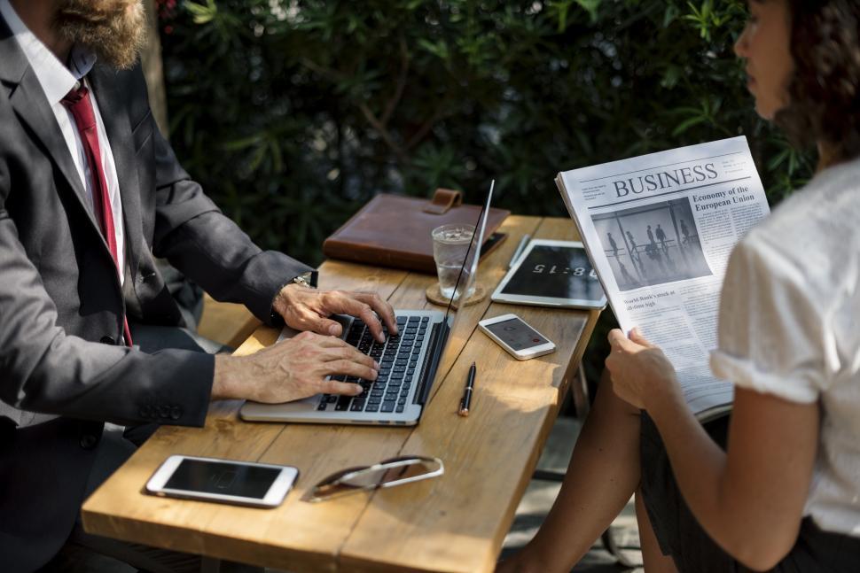 Free Image of Close up of two business people talking over news of the day 