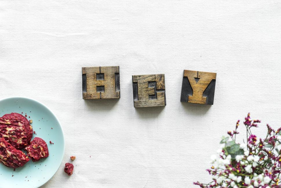 Free Image of Overhead view of the word HEY written with wooden alphabet blocks 