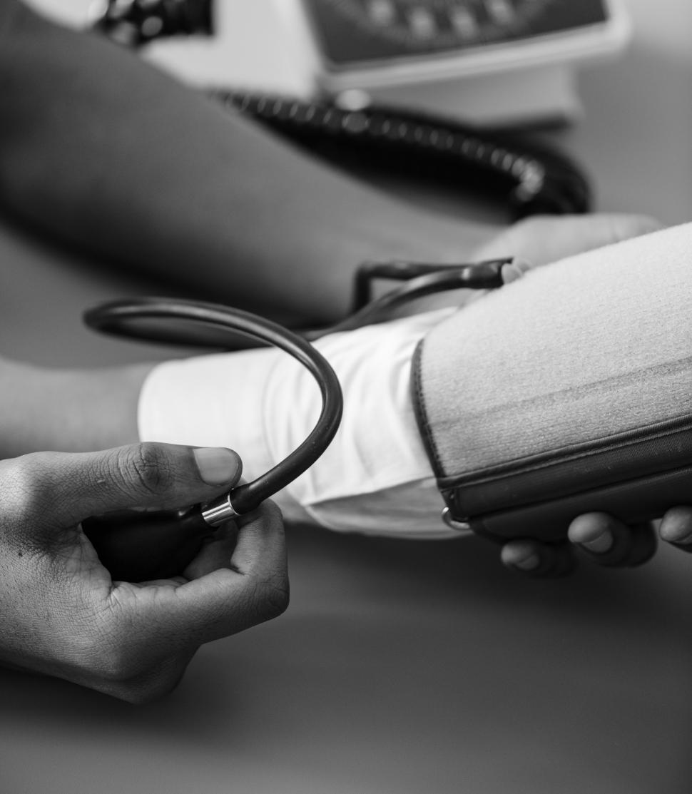 Free Image of Close up of a doctor s hands monitoring blood pressure 