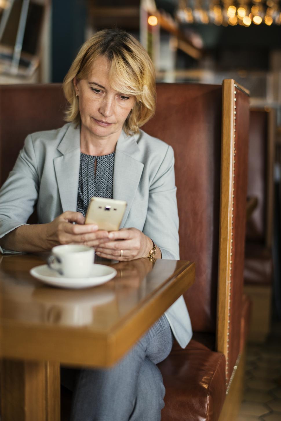 Free Image of A Caucasian businesswoman looking at her smart phone 