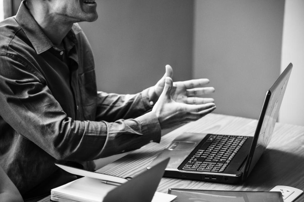 Free Image of Black and white close up of young man with computer 