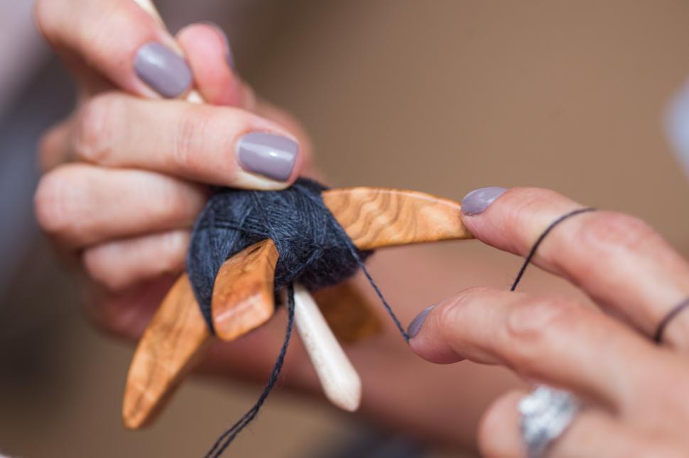 Free Image of Hands of woman spinning yarn 
