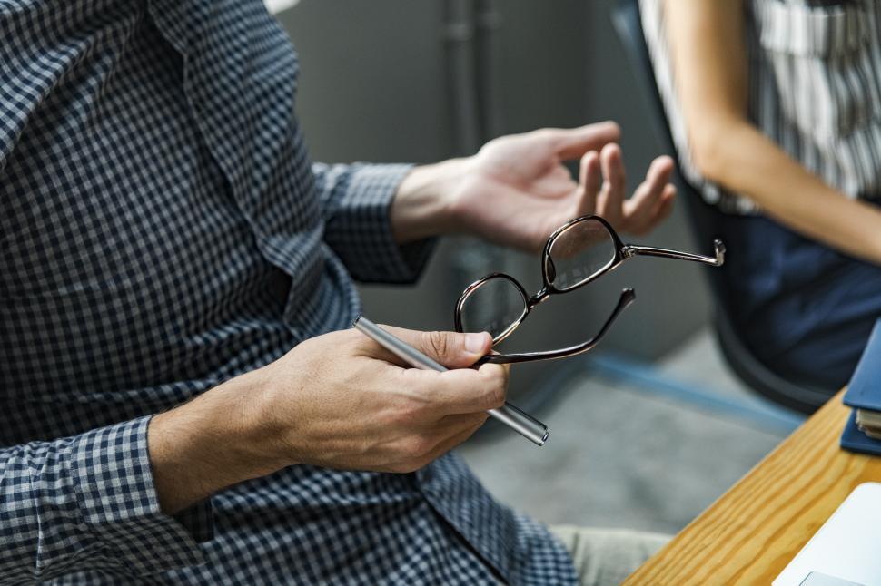 Free Image of Close up of spectacles in a persons hand 