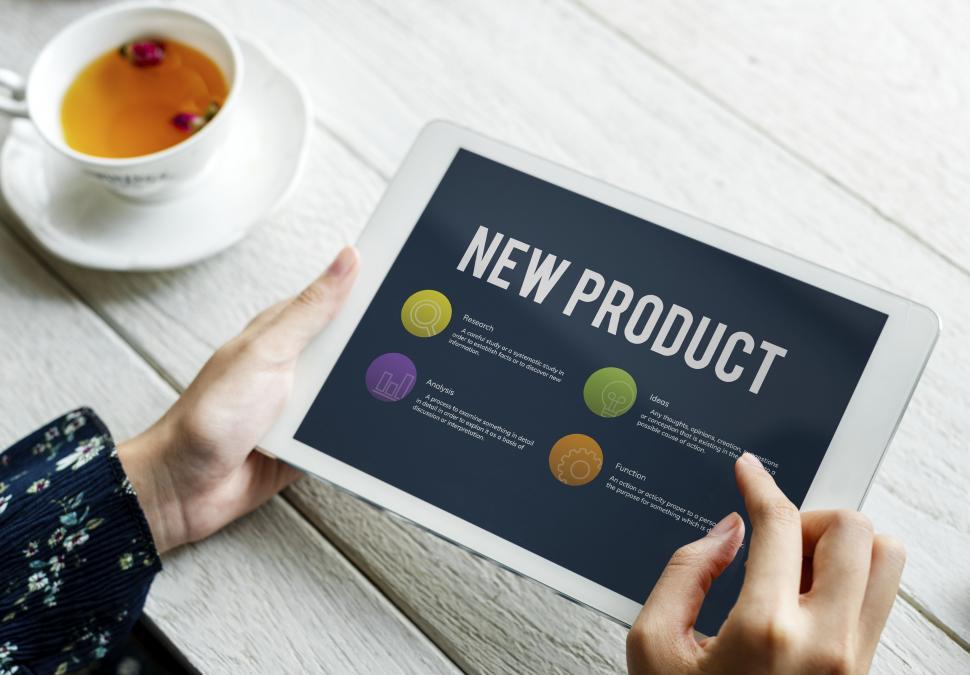 Free Image of Close up of a hands holding a tablet PC with New Product display 