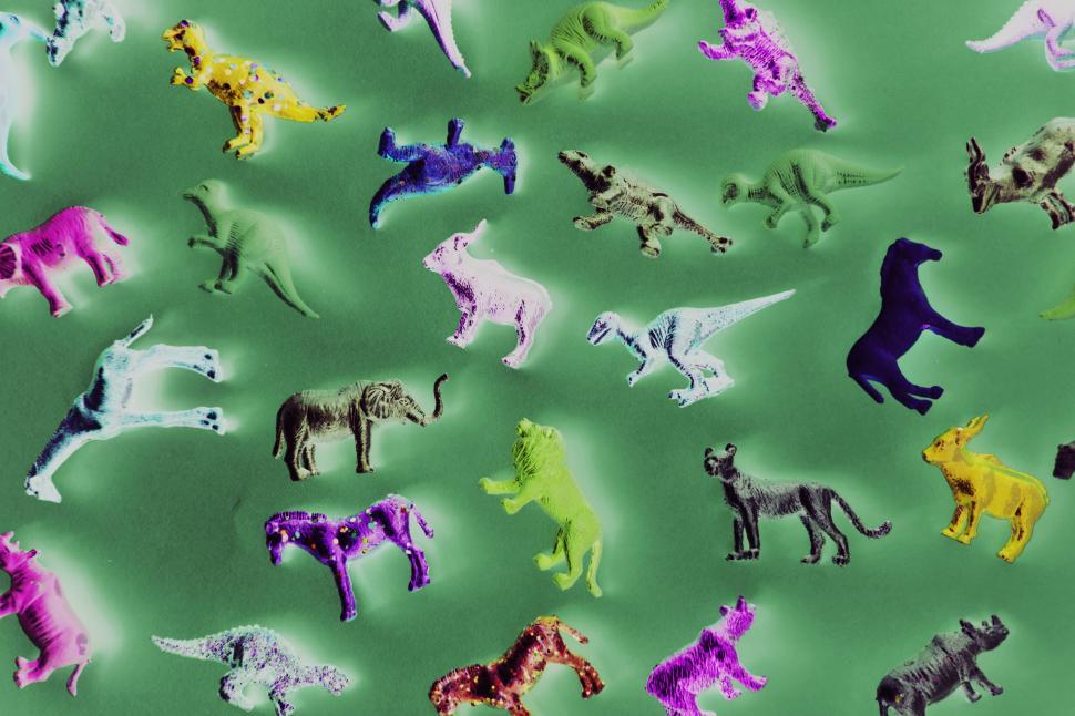 Free Image of Inverted processed color image of toy animals on green surface 