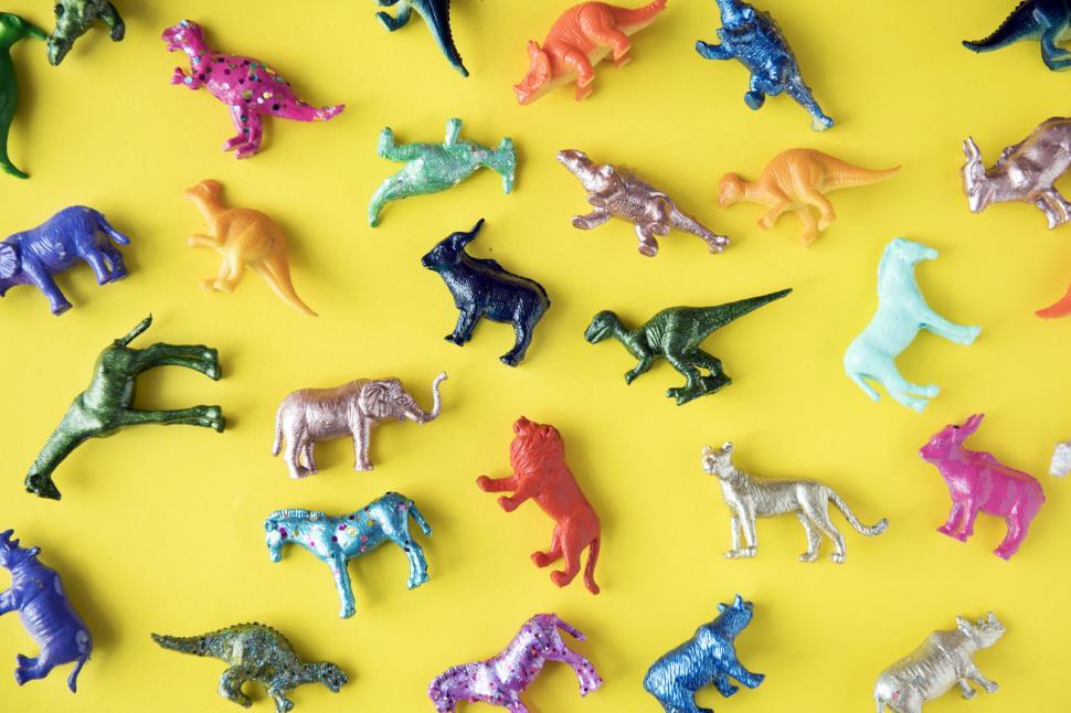 Free Image of Colorful toy animals on yellow surface 