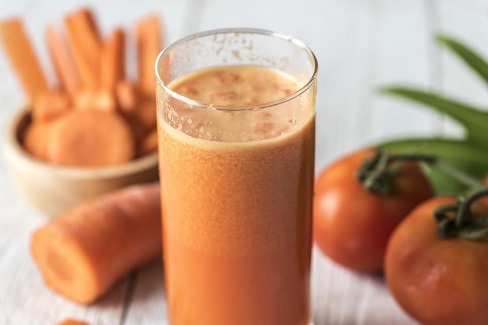 Free Image of Close up of carrot and tomato smoothie served in a glass 